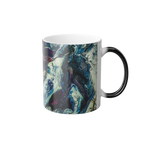 Freebrd Abstract Art Color Changing Mug displaying navy, white, gold, magenta, black and shades of red. Black handle display when the handle is cold, when hot the handle turns white. 