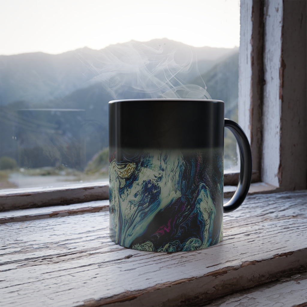 Freebrd Abstract Art Color Changing Mug displaying navy, white, gold, magenta, black and shades of red: Cup half full with hot beverage, showing fill level.
