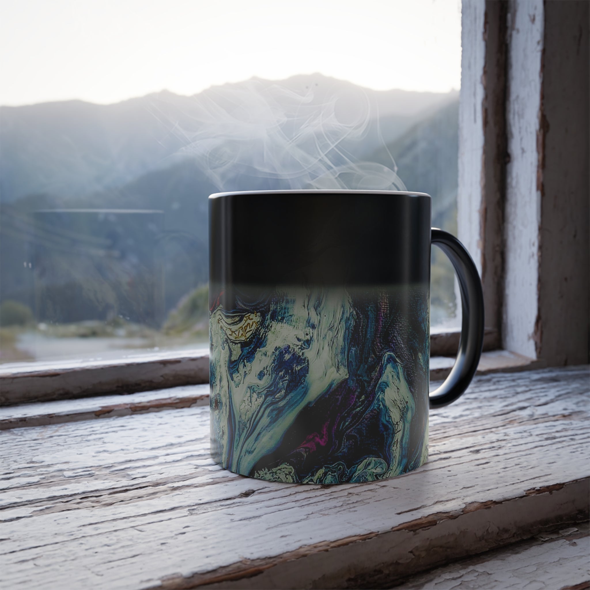 Freebrd Abstract Art Color Changing Mug displaying navy, white, gold, magenta, black and shades of red: Cup half full with hot beverage, showing fill level.
