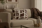 Beige sofa with a Abstract Brown Brushstroke Lumbar Pillow in a living room setting.