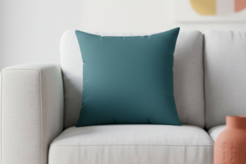 Abstract Teal Faux Suede Square Pillow on a beige couch.