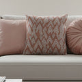 Adore Pink Boho Ikat Patterned Woven Pillow on a light gray sofa.