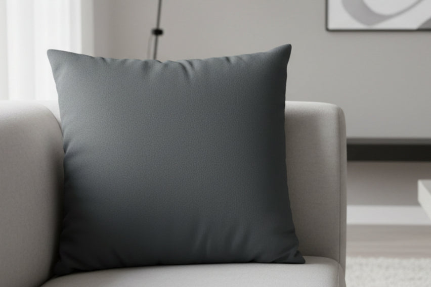 Anchor Grey Faux Suede Luxury Square Pillow on a light gray sofa in a minimalistic living room.