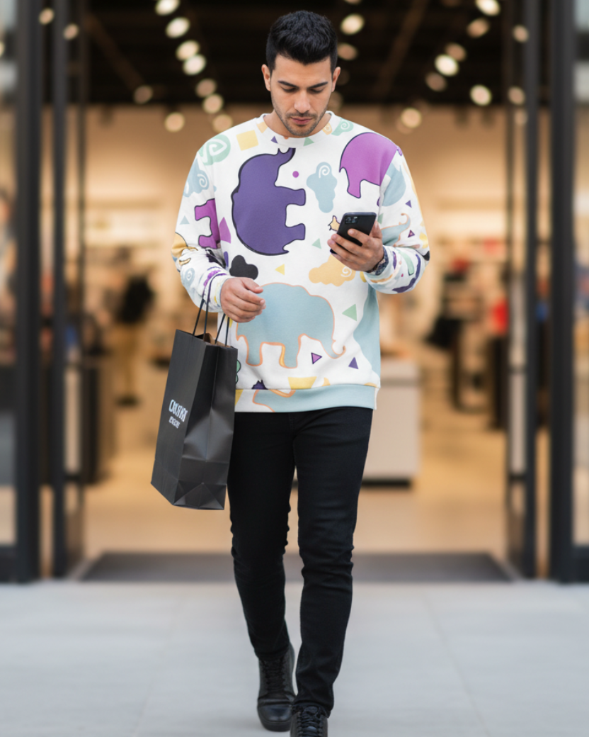 Man wearing a Freebrd Animal Clouds sweatshirt, holding a phone and a black shopping bag