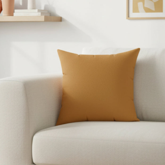 Apple Cider Faux Suede pillow on a beige sofa in a living room setting.