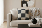 Beige sofa with Atomic Grey Woven Checkered Decorative Pillow and decorative items in a living room setting
