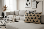 Modern living room with a gray sectional sofa, Beige & Black Geometric Triangle Lumbar Pillow, decorative pillows, and abstract art on the wall.