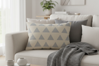 Beige & Stardust Grey Geometric Triangle Lumbar Pillow on a beige couch 