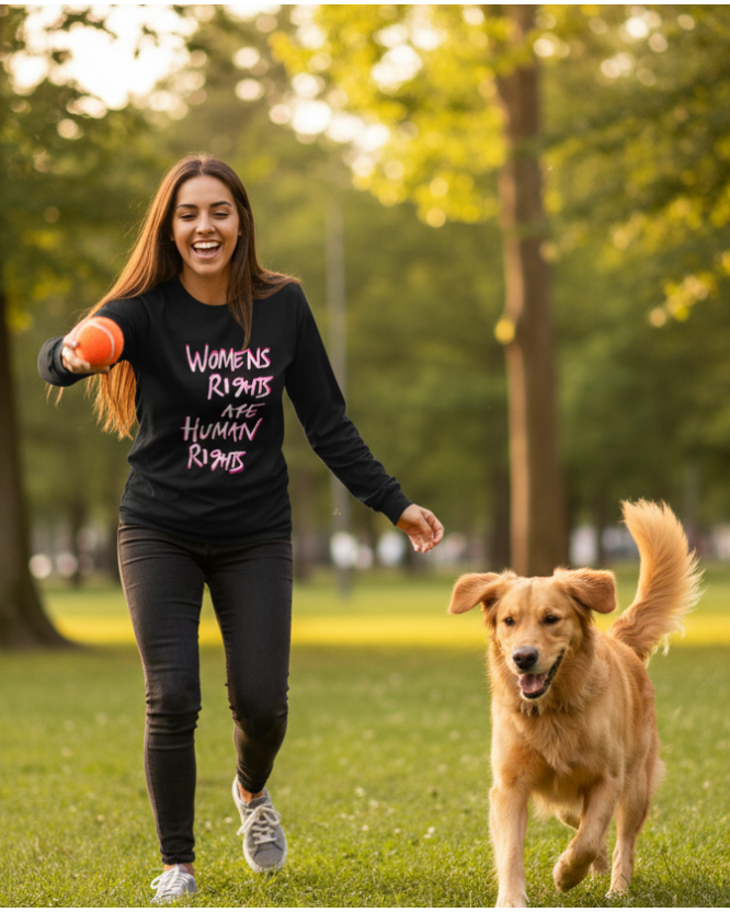 Woman running with a dog in a park wearing a black Freebrd women's rights long sleeve shirt