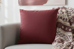 Bloodstone Red luxury Faux Suede Pillowcase pillow on a gray sofa with a patterned blanket
