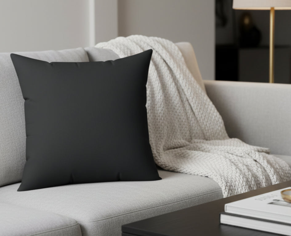 Carbon Fiber Luxury Faux Suede Pillow on a gray sofa with a blanket and books in the background