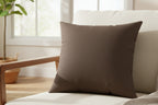 Country Brown Faux Suede Square Pillow on a white chair in a bright sun room
