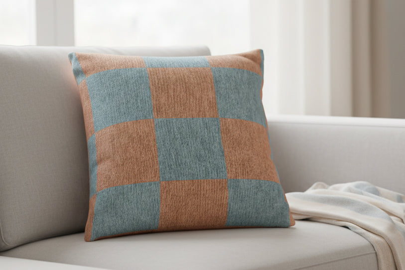 Danish Blue Vintage Salmon Checker Woven Pillow on a light-colored sofa with a neutral background