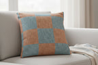 Danish Blue Vintage Salmon Checker Woven Pillow on a light-colored sofa with a neutral background