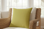 Dull gold Faux Suede Square Pillow in wicker chair