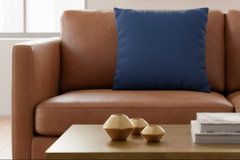 Elegant Blue Luxury Faux Suede Square Pillow on a leather sofa with gold decor.