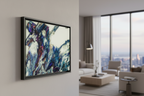 Black Framed Freebrd "Afrostar" abstract painting in a modern living room with cityscape view