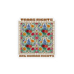 A die-cut magnet featuring a colorful floral pattern in the center with brown text reading 'TRANS RIGHTS ARE HUMAN RIGHTS' on a white background.