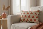 Beige sofa with a Geometric Terracotta Triangle Lumbar Pillow in a living room setting.