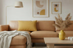 Gold Ochre Lumbar Accent Pillow on a brown sofa and decorative elements.