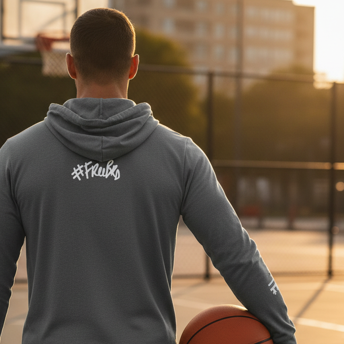 Person holding a basketball on an outdoor court with '#Freebrd' branding