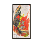 Side view of the “Grid Riser Rhino” Abstract Framed Art by FREEBRD on a 1.25” canvas with a 16" x 32” Vertical frame, showcasing vibrant orange, red, green and black acrylic textures with hints of vivid yellow, coral and gold, framed in an espresso wood FSC certified frame. 