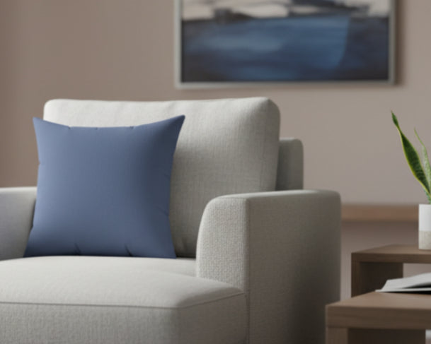  Navy Dust hue Faux Suede Square Pillow in a lounge chair with matching decor