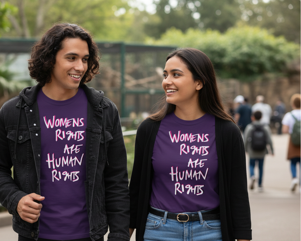 Two people wearing Freebrd designed purple shirts with  'Women's Rights Are Human Rights' text, standing outdoors.