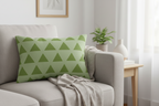 Schist Olive Green Geometric Triangle Lumbar Pillow on a gray sofa in a living room setting.