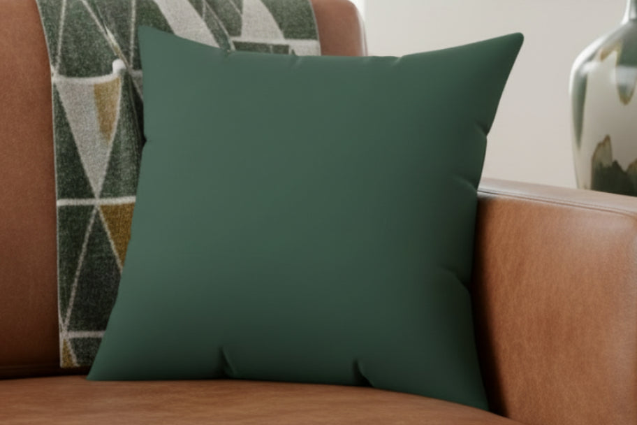 Stromboli Faux Suede Square Pillow on a brown sofa with a blanket.