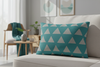 Teal Stardust Grey Geometric Triangle Lumbar Pillow on a beige couch in a living room setting.