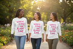 Three women walking outdoors wearing Freebrd designed  'Women's Rights Are Human Rights' white long sleeve shirts.