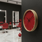 Modern Minimal Wooden Red Silent Wall Clock on a black wall, blurred interior setting with red chairs.