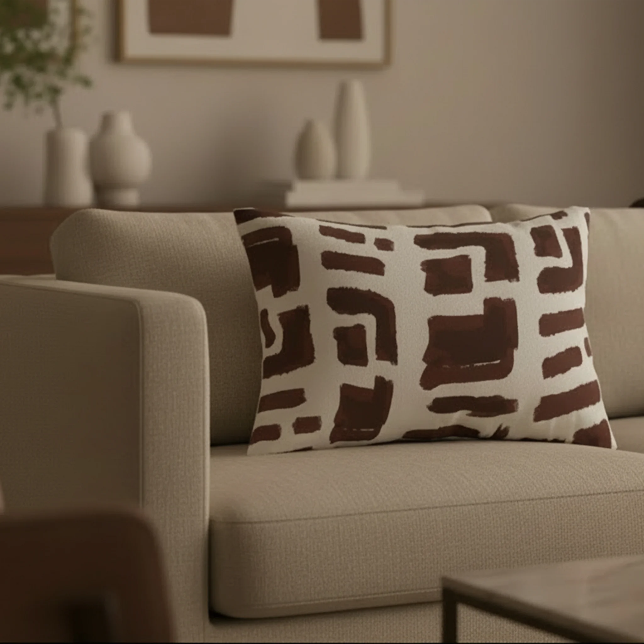 Abstract brown brushstroke lumbar pillow styled on a couch in a modern living room.