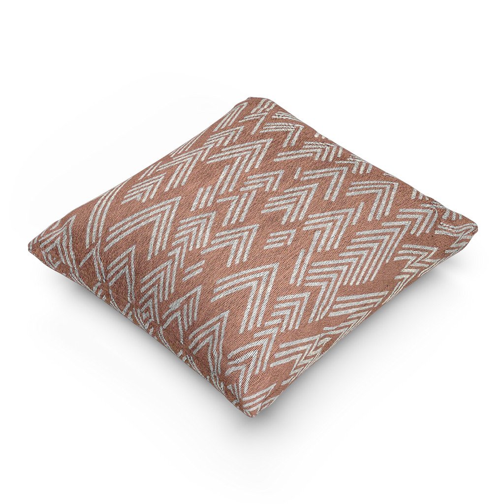 A side view of the Adore Pink Boho Ikat Woven Pillow showing an adore pink background and ivory white chevron ikat styled lines.