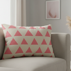 Adore pink triangle pattern lumbar pillow styled on a couch in a modern living room. 
