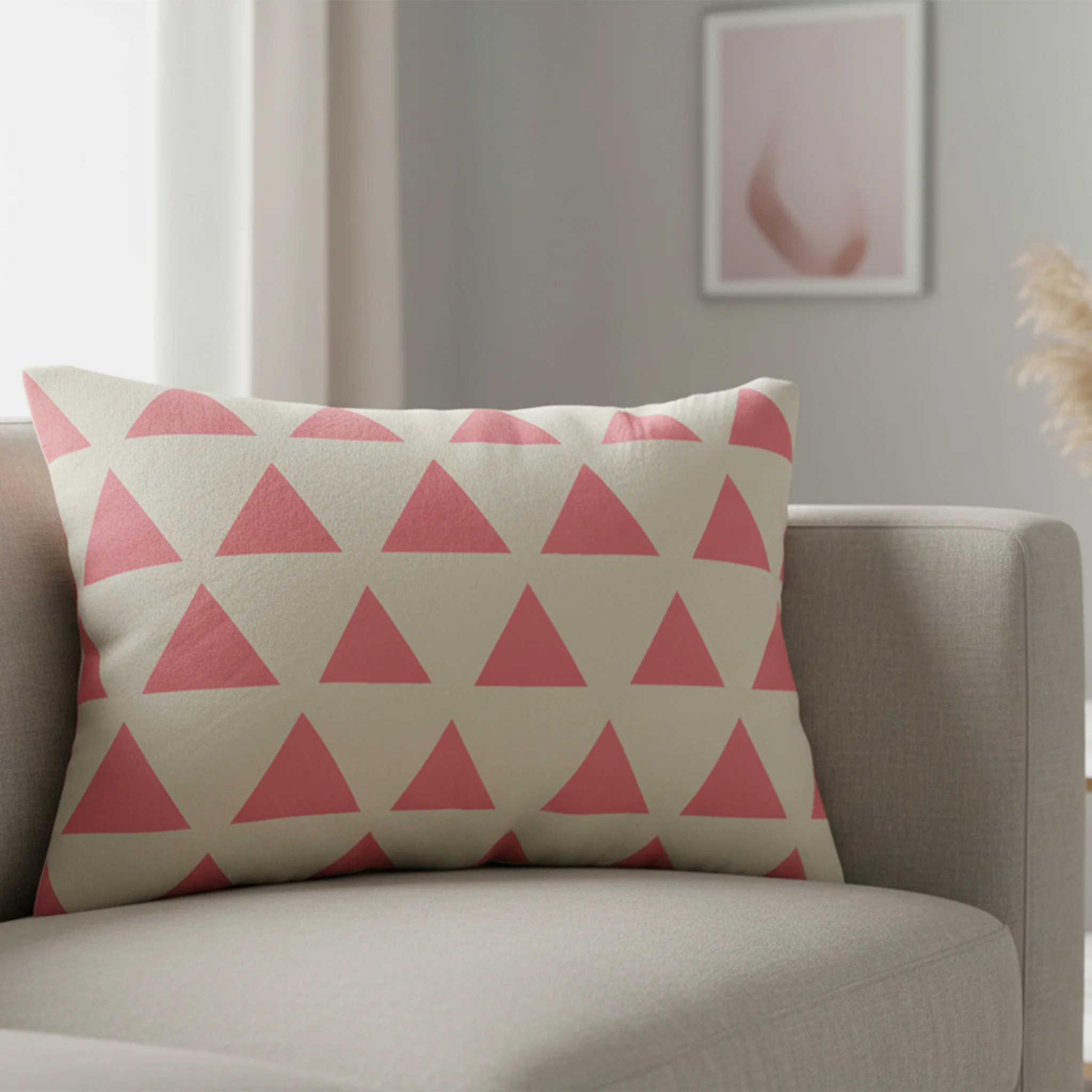 Adore pink triangle pattern lumbar pillow styled on a couch in a modern living room. 
