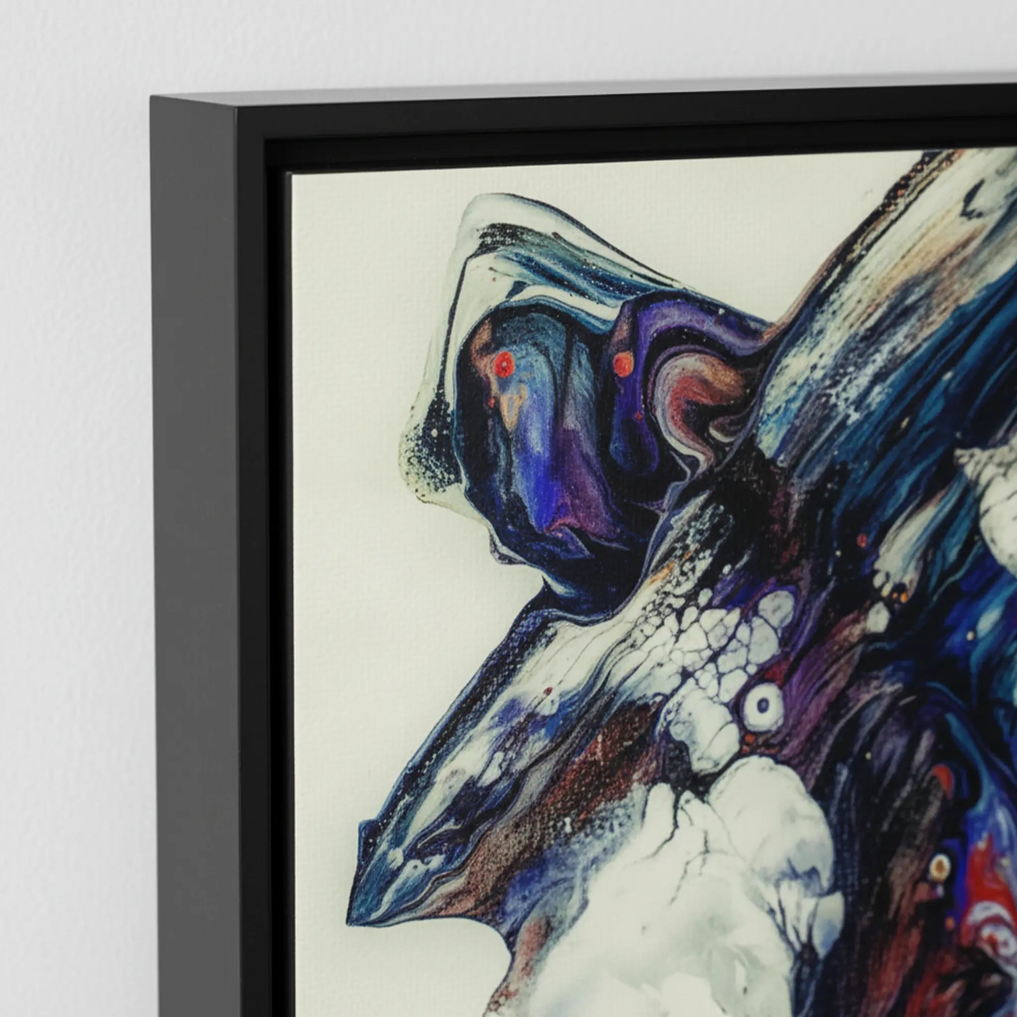 Close-up texture detail of "Afrostar" framed abstract canvas by FREEBRD — fluid pour art in navy, indigo, purple and ivory on premium DTF canvas with black wood frame and archival matte finish.
