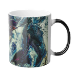 A right side view of the 11 oz abstract coffee cup showing the ‘Afrostar’ acrylic hand-poured canvas artwork design on the right side that displays navy, white, gold, magenta, black and shades of red acrylic paint textures wrapped around the cup, with a black c-shaped handle. 