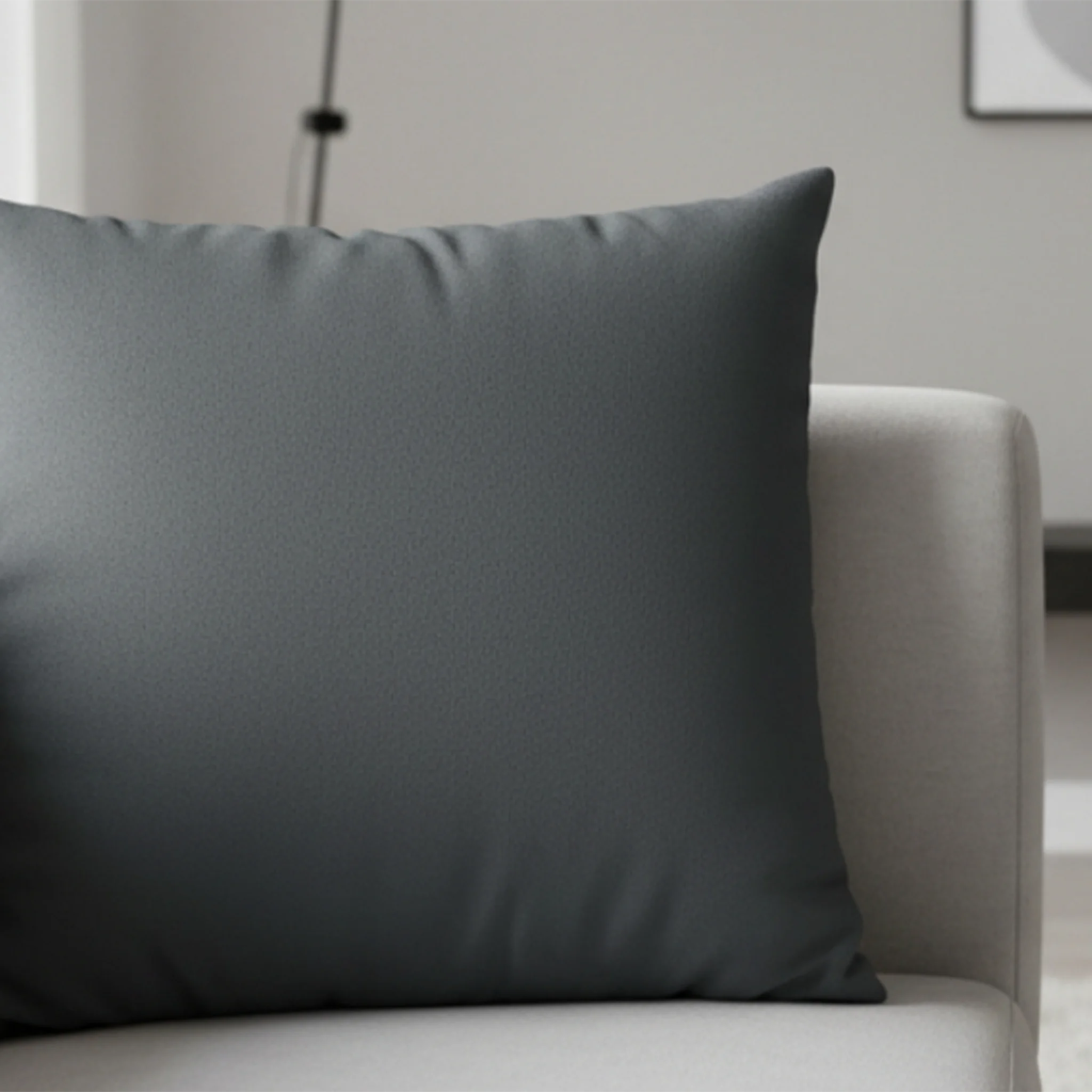 Anchor Grey faux suede pillow case styled on a couch in a modern living room.