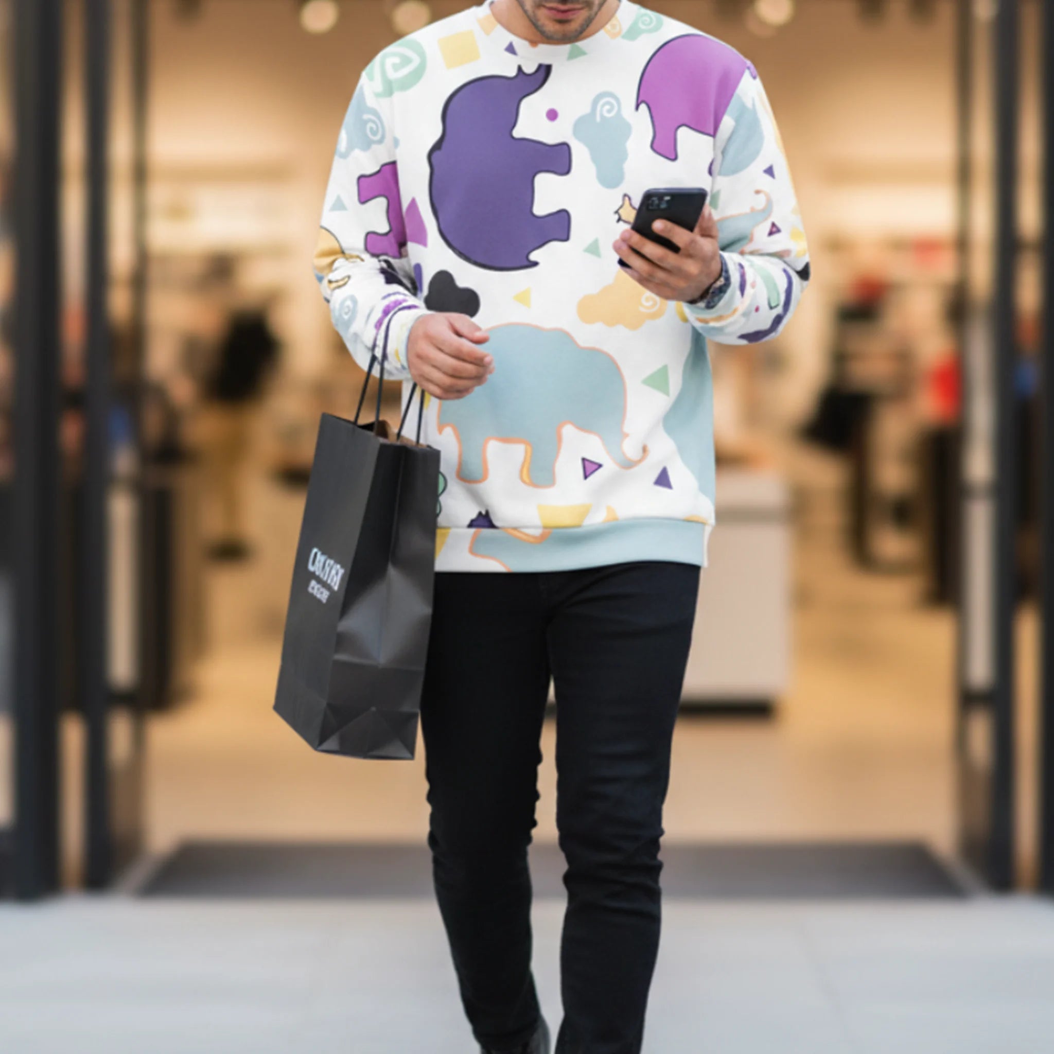 Animal Clouds crewneck sweatshirt, elephant and giraffe all-over print, purple sea green yellow, styled with black denim jeans, front view.