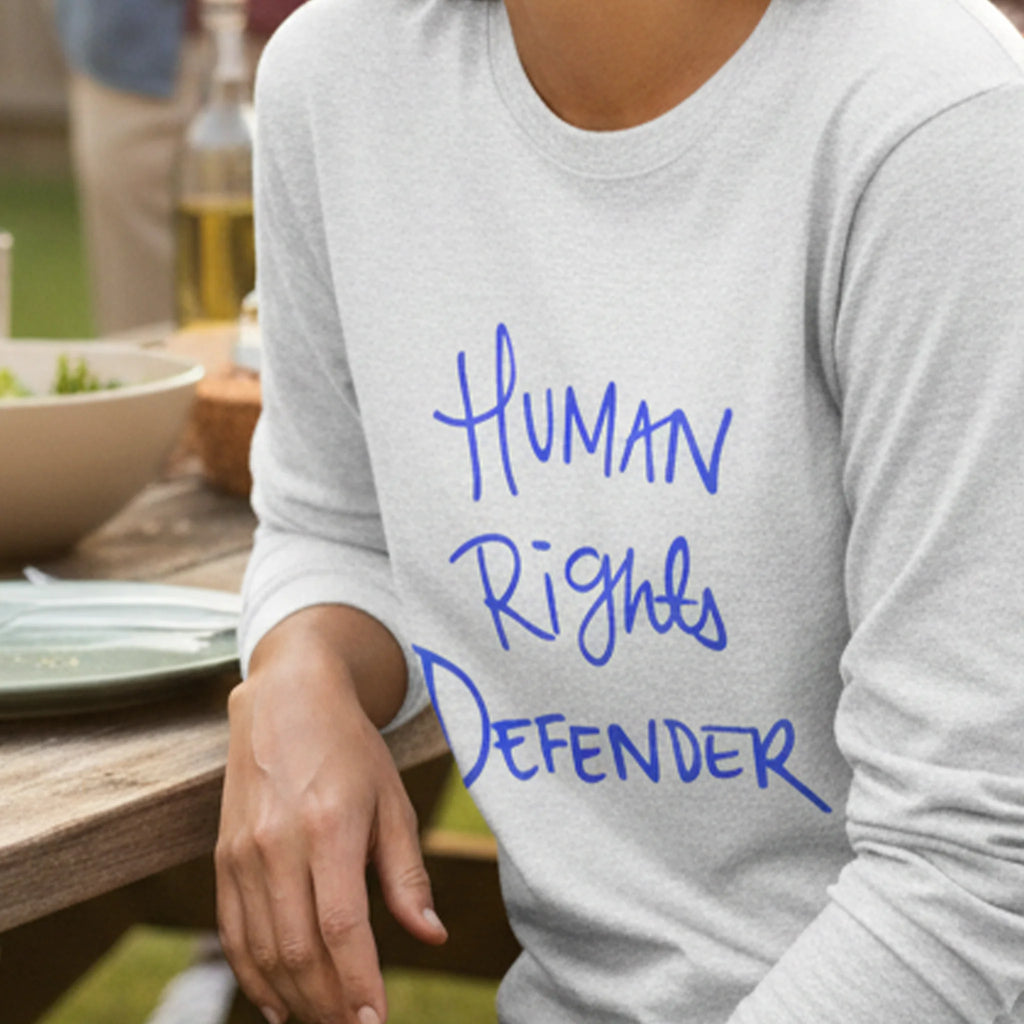 Ash Human Rights Defender long sleeve tee, royal blue graphic, outdoor lifestyle front view.