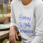 Ash Human Rights Defender long sleeve tee, royal blue graphic, outdoor lifestyle front view.