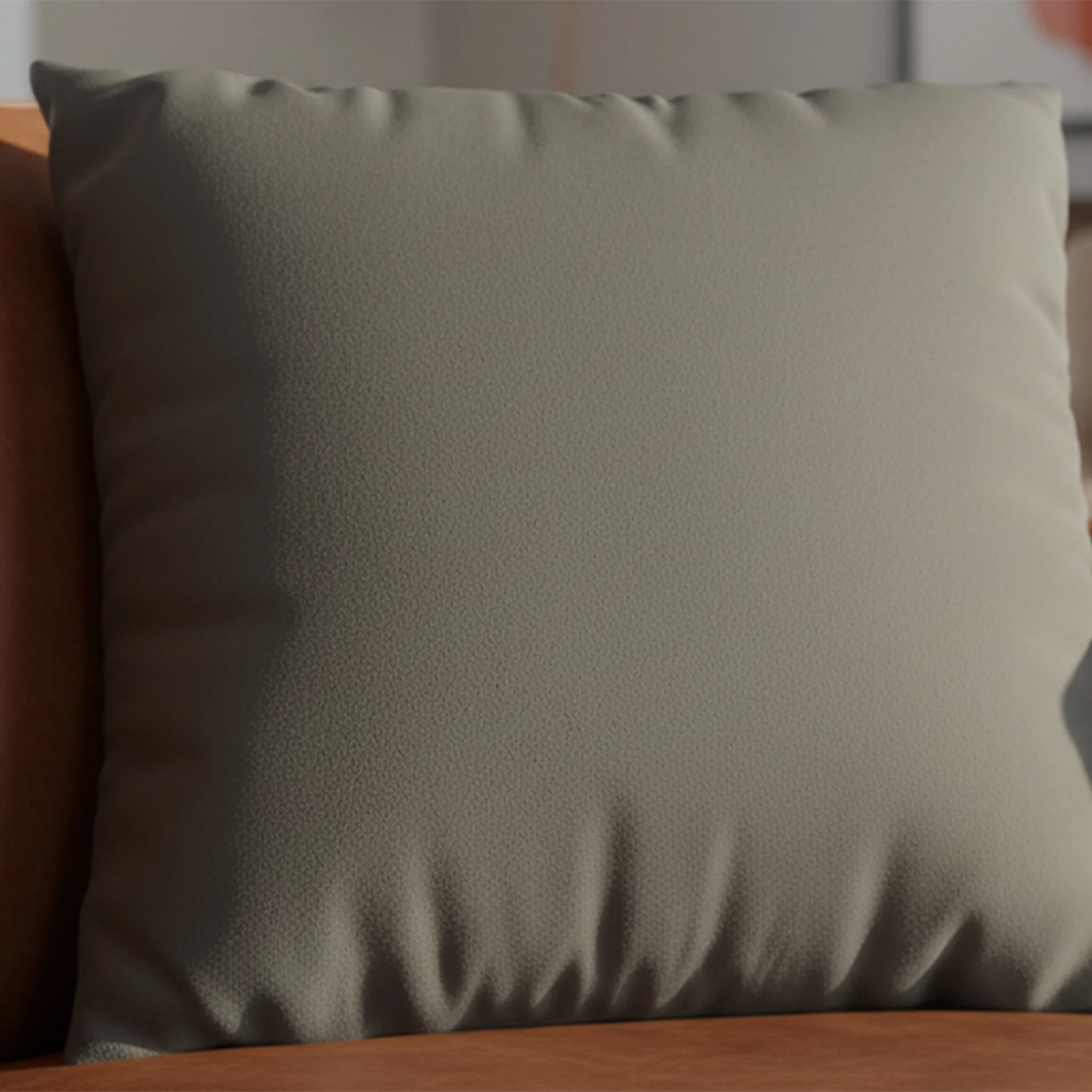 Atomic Grey faux suede pillow case styled on a couch in a modern living room.