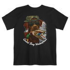 A black t-shirt featuring the Good Boy Waterfowl graphic of a chocolate Labrador wearing sunglasses and a camo snapback, holding a mallard duck, with a watercolor outdoor scene and 'Good Boy Waterfowl' script below.