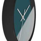 Abstract teal silent wall clock, black base, white hands, black markers, 10 inch, side view.