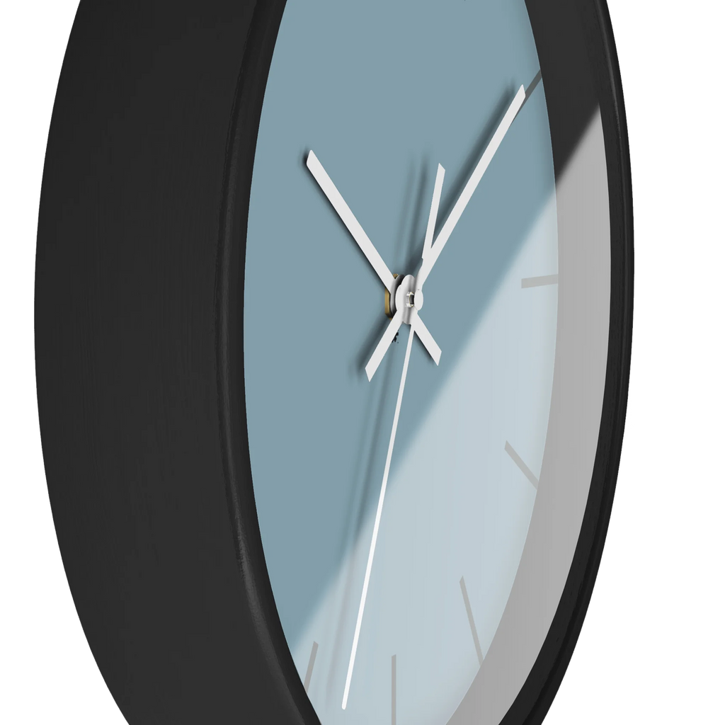 Danish blue minimalist wall clock with black wooden base, white hands, and dark grey markers, side view.