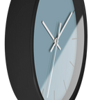 Danish blue minimalist wall clock with black wooden base, white hands, and dark grey markers, side view.