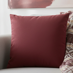 Bloodstone Red faux suede pillow case styled on a couch in a modern living room.