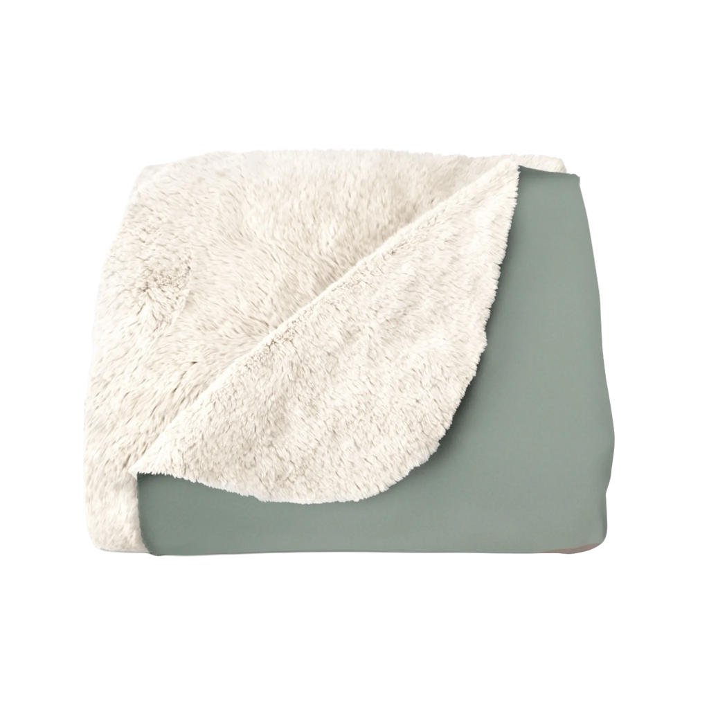 Folded sherpa blanket with cream plush backing turned over to show the muted sage printed side.